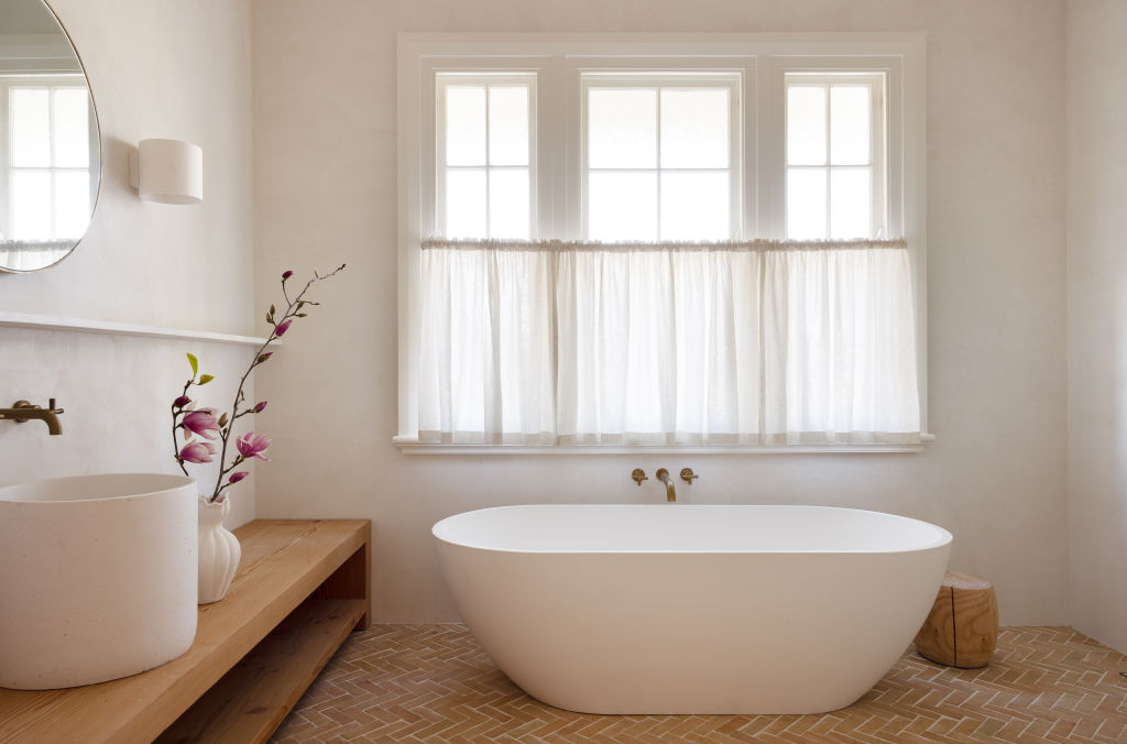 The Moroccan-tinged bathrooms feature gorgeous, textured herringbone tiles. Photo: Louise Roche - The Design Villa