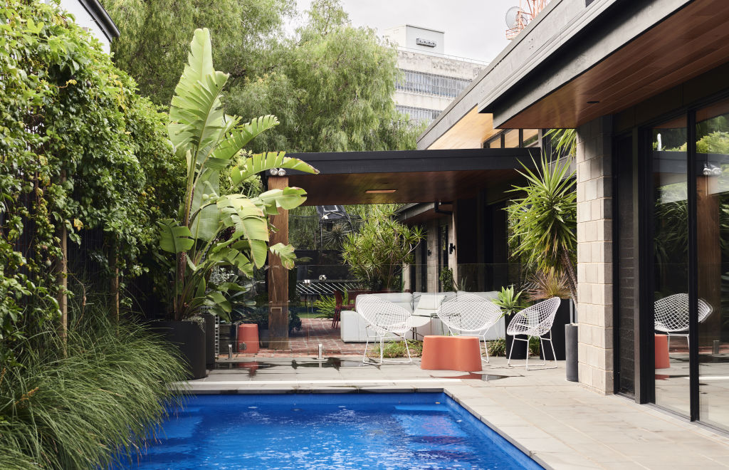 The pool area enjoys views of Ripponlea Estate’s trees. Fez stools by Chris Connell. Styling: Annie Portelli and Sarah Hendriks. Photo: Eve Wilson