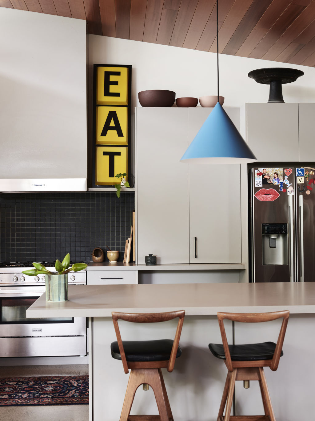 TH barstools (bought from an op-shop for $10 each).&nbsp;Nick Scali&nbsp;pendant. ‘Eat’ light-up sign bought from Facebook Marketplace.  Styling: Annie Portelli and Sarah Hendriks. Photo: Eve Wilson