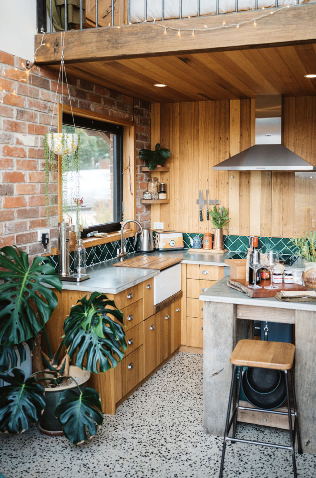 The walls, drawers and ceiling in the kitchen are made from recycled timber from an old basketball court. Photo: Harley Brown