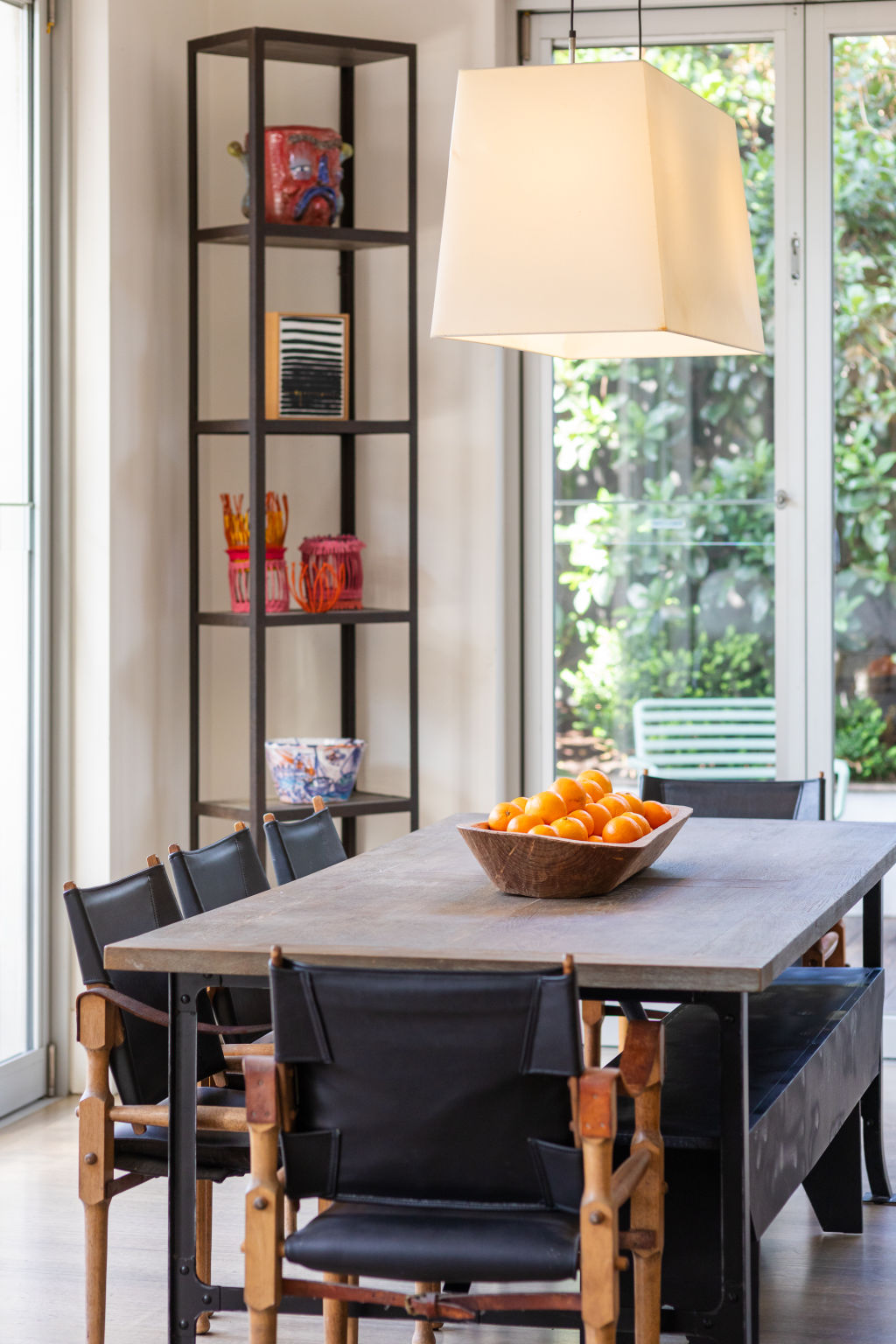 The generous open-plan kitchen, living and informal dining area is wrapped in glass on two sides and washed in natural light. Photo: Greg Briggs