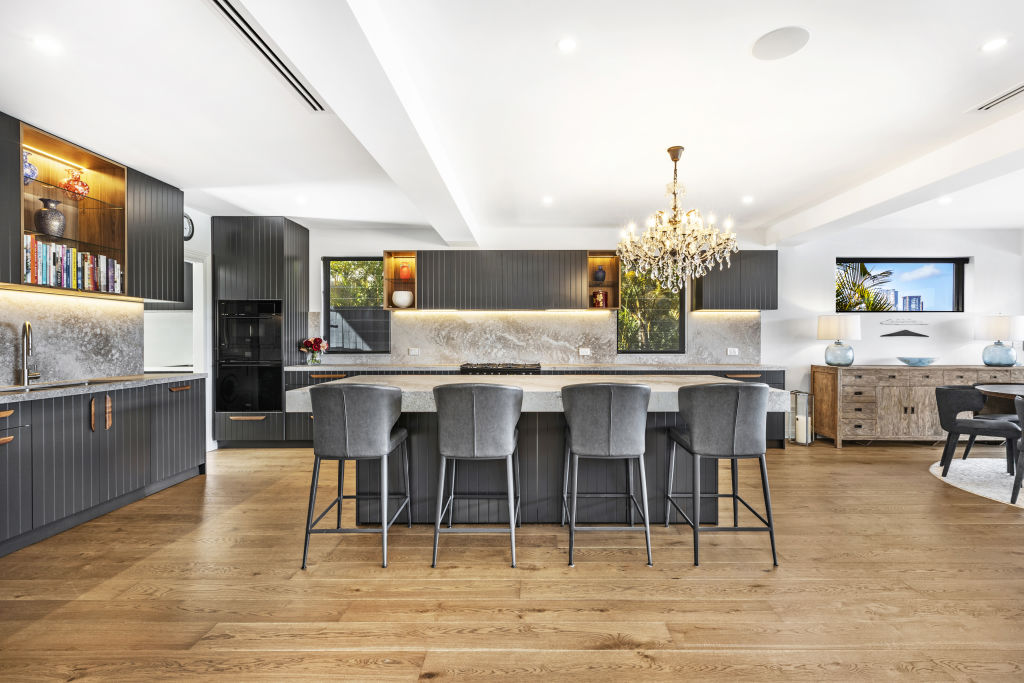The showstopping kitchen has a huge stone-topped island bench. Photo: Supplied