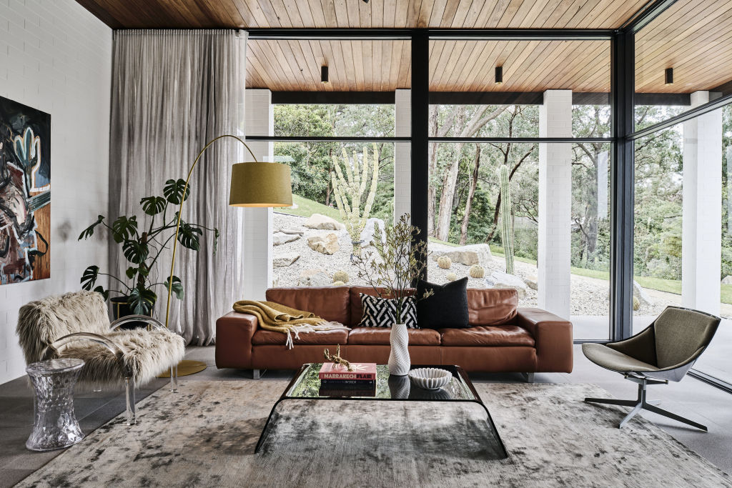Floor-to-ceiling windows bring the outdoors in in the light-filled living room. Photo: Supplied