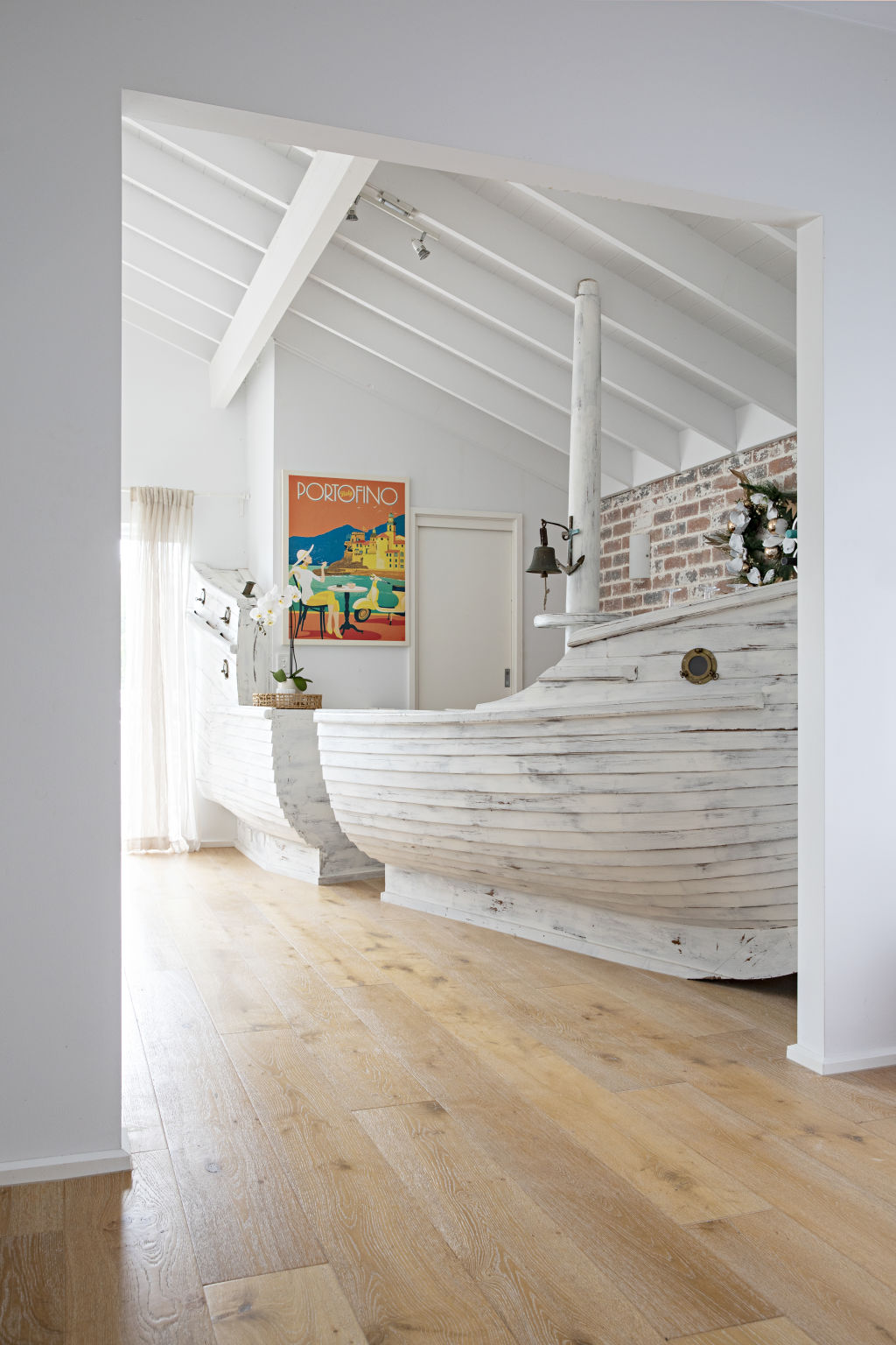 The home's previous owner installed a large wooden boat in the living room, and it's since been repurposed into a bar. Photo: Natalie Jeffcott