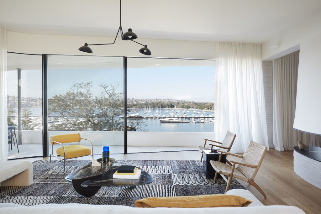 The living room and balcony with harbour views. Photo: Supplied