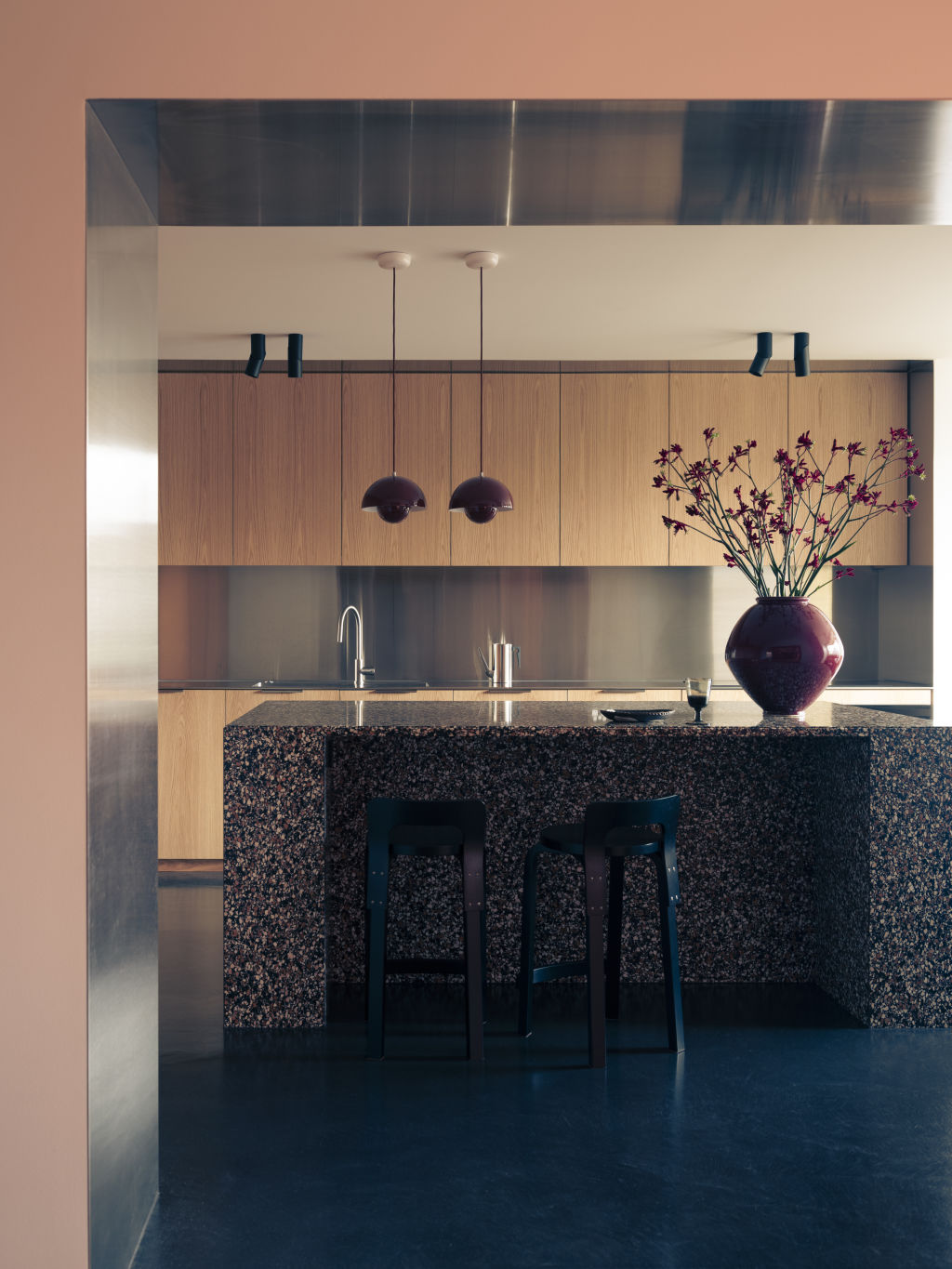 Studio Prineas principal Eva-Marie Prineas selected stainless steel for her residential project, Doria Apartment in Sydney's Double Bay, layering it with timber, terracotta-toned cabinetry, and terrazzo. Photo: Felix Forrest
