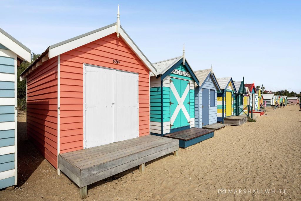 Neighbourly fun: no need for an umbrella or cabana if you have the cash to shell out for a Brighton beach box. Photo: Marshall White Bayside