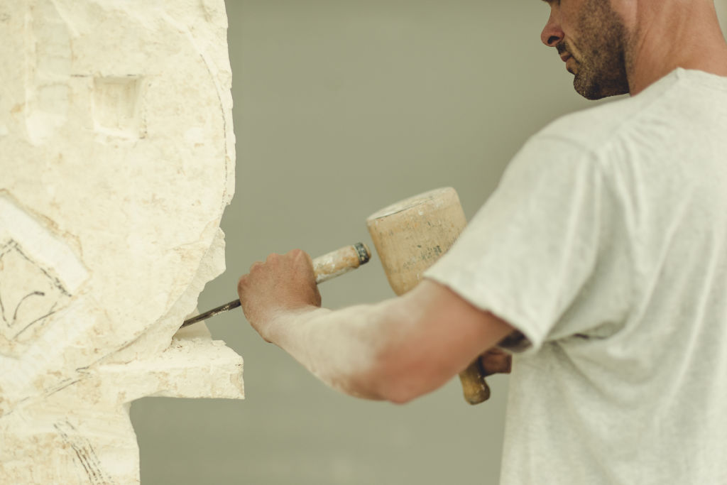 Clark uses traditional stone mason's tools in his scuplting. Photo: Hilary Walker