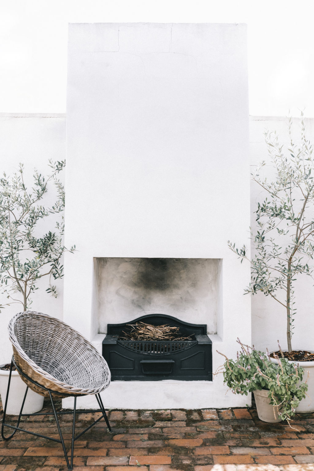 A cast-iron outdoor fireplace was salvaged from Ric and Moir’s family home renovation and is a feature in the courtyard. Photo: Natalie Salloum