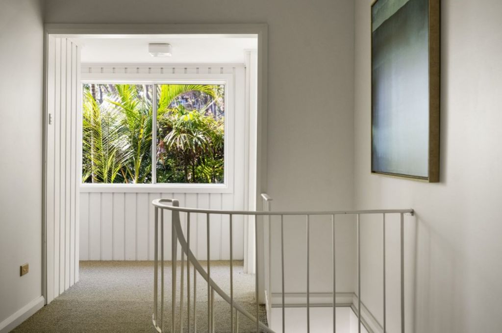 The statement spiral staircase leads to the newly-updated ground floor. Photo: LJ Hooker Palm Beach