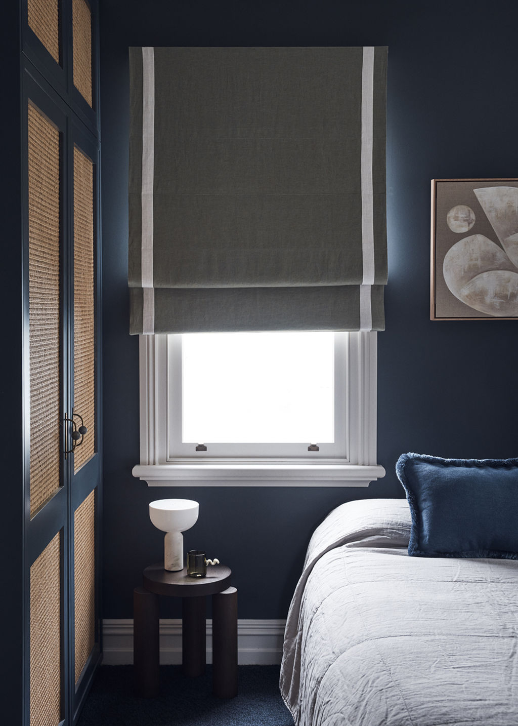 Deeper tones of blue have been used in the bedroom. Photo: Damian Bennett