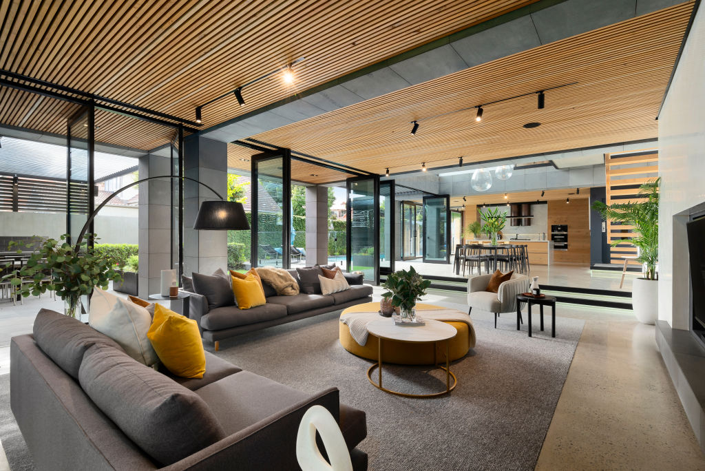 Floor-to-ceiling windows surround the living room.