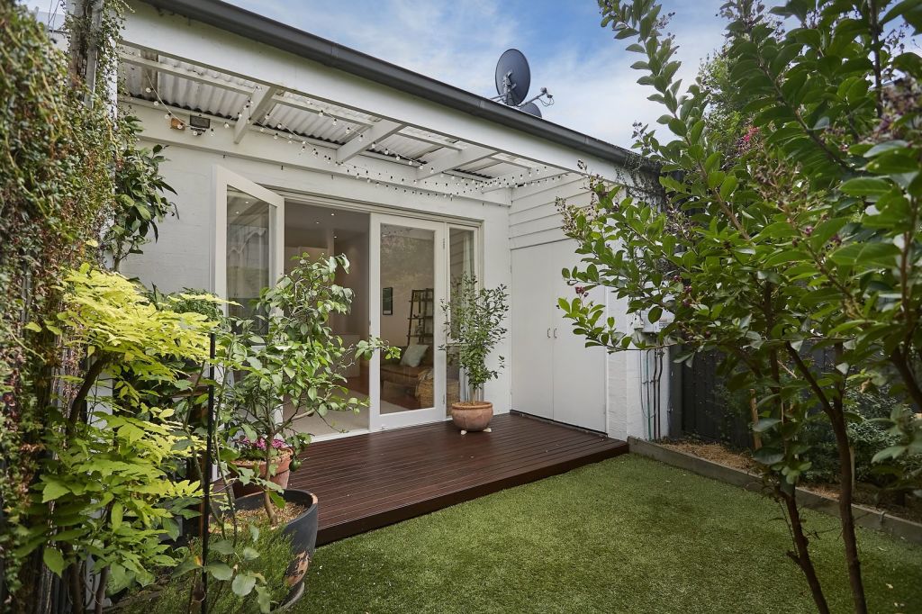 They then tackled bigger updates, completing full bathroom and kitchen renovations and replacing the pebbled stones in the backyard with a more kid-friendly artificial turf. Photo: Belle Property