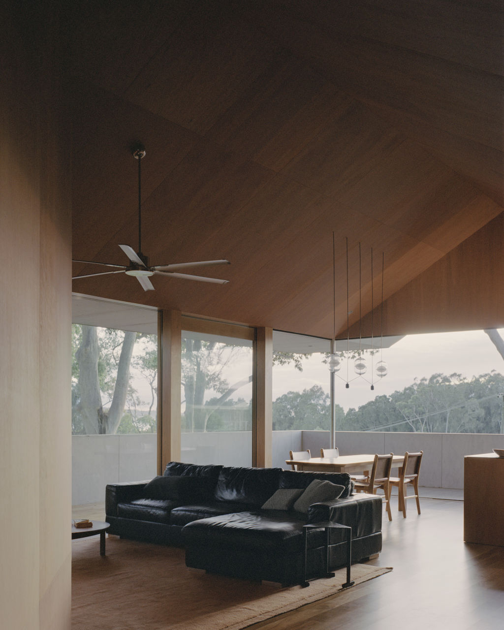 The living, dining and kitchen areas sit under raked five-metre ceilings. Photo: Rory Gardiner
