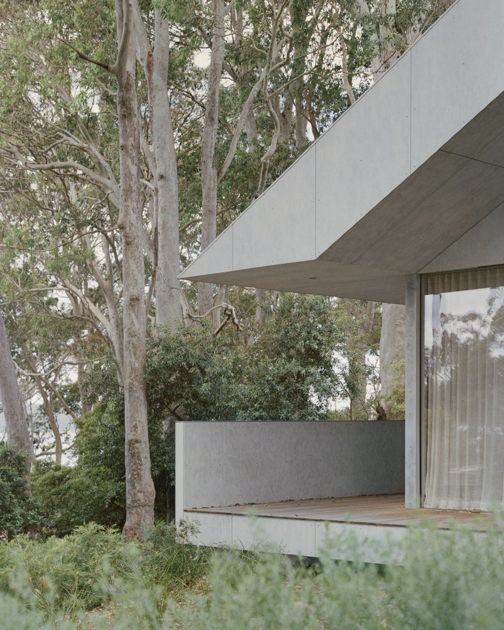 A covered deck wraps around to a street-facing porch. Photo: Rory Gardiner