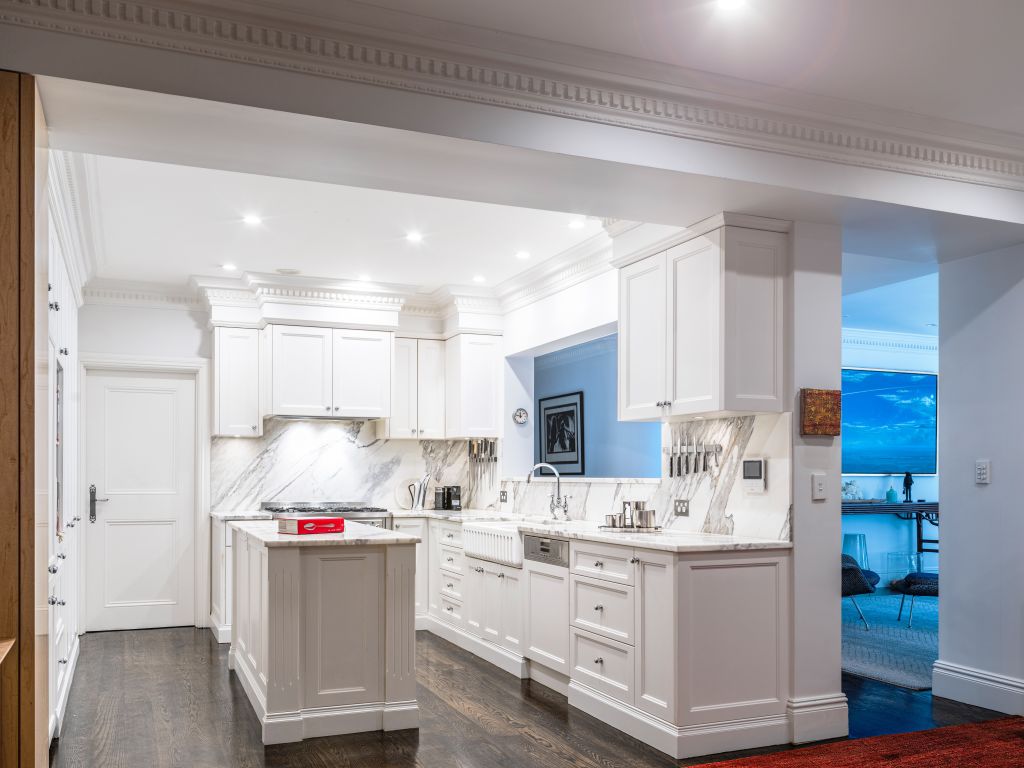 The all-white kitchen features calacatta marble and shaker joinery. Photo: Supplied