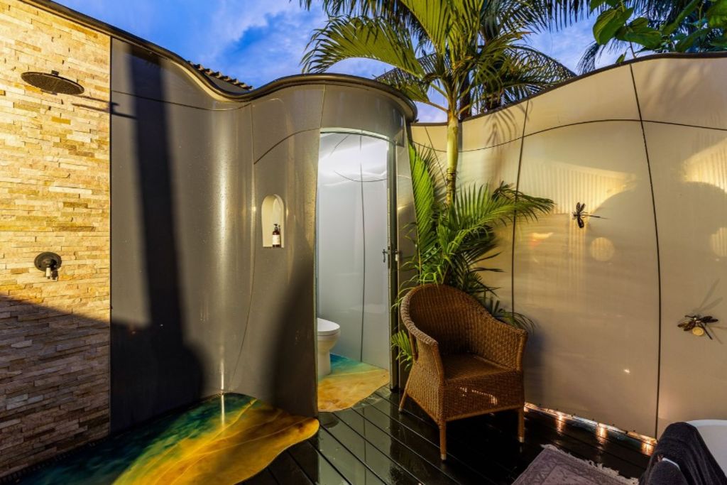 The open-air space has a space-age toilet and low-set bathtub. Photo: Ray White Broome