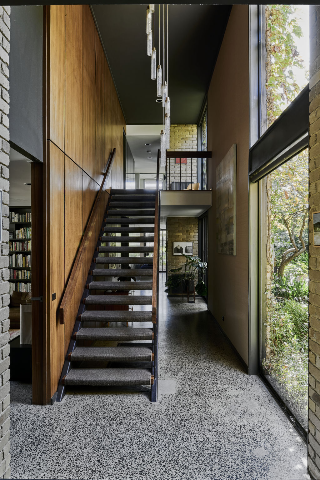 A soaring double-height volume allows the staircase full, fabulous reign. Photo: Supplied