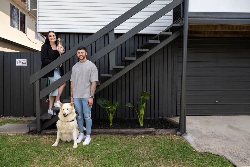 Darcy and Jordan Modina with their two dogs in their Kuraby, Queensland, home. They were able to buy a house they loved with the help of Great Southern Bank. Photo: Great Southern Bank &amp; daniel chabierski - kdmedia.com.au