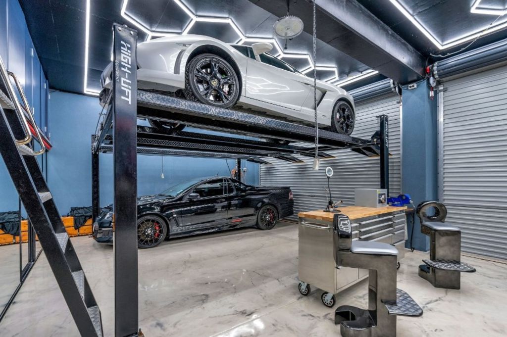 A six-car garage has been transformed into a man cave with a mechanic's workshop. Photo: Ray White Cairns and Cairns Beaches