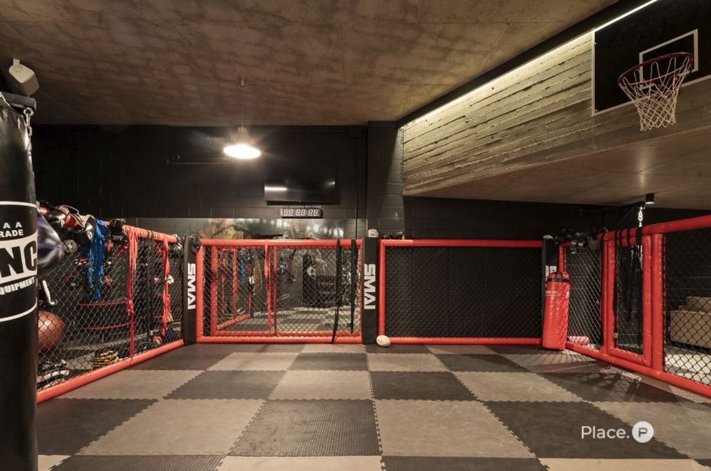 The "secret bunker" contains the UFC ring and extensive home gym. Photo: Place Estate Agents Ascot