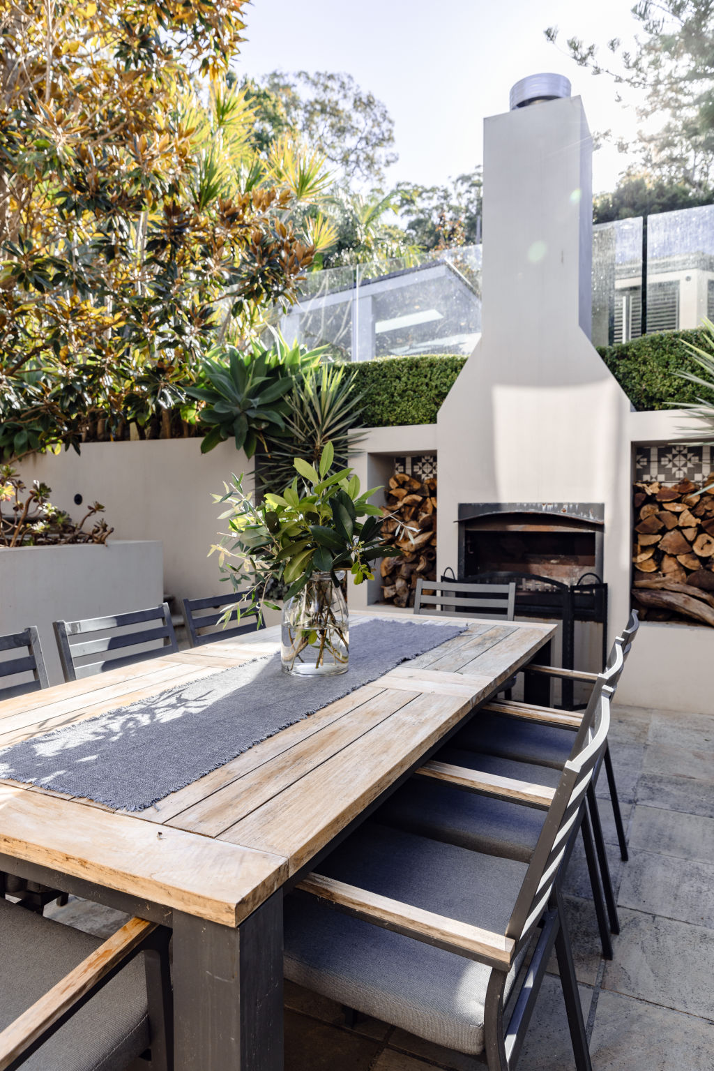 The outdoor dining area with a wood-burning fireplace. Photo: Trudy Pagden