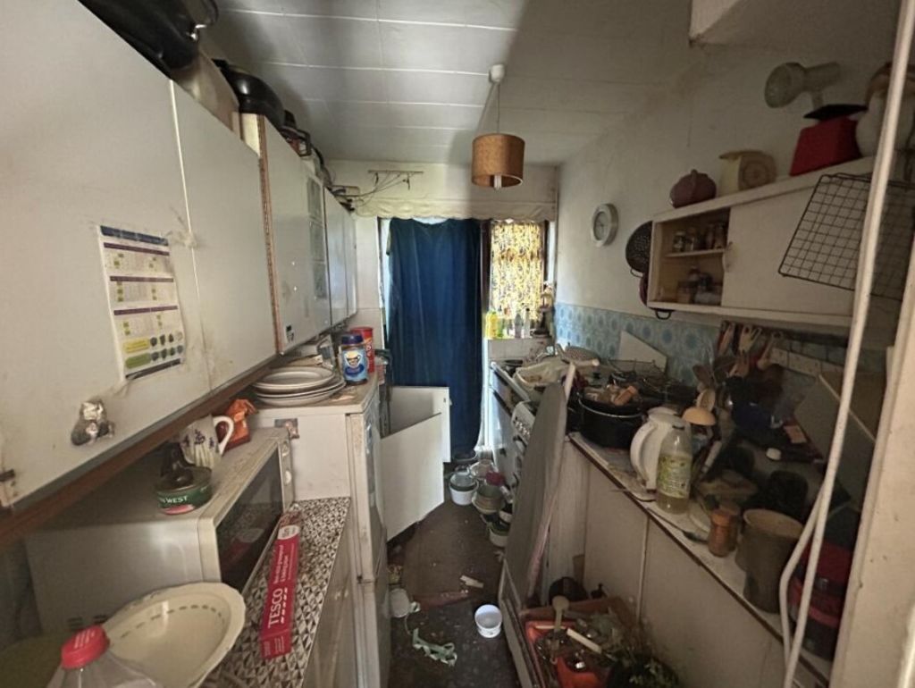 The kitchen is also overflowing with clutter. Photo: Allsop Auctions/Rightmove