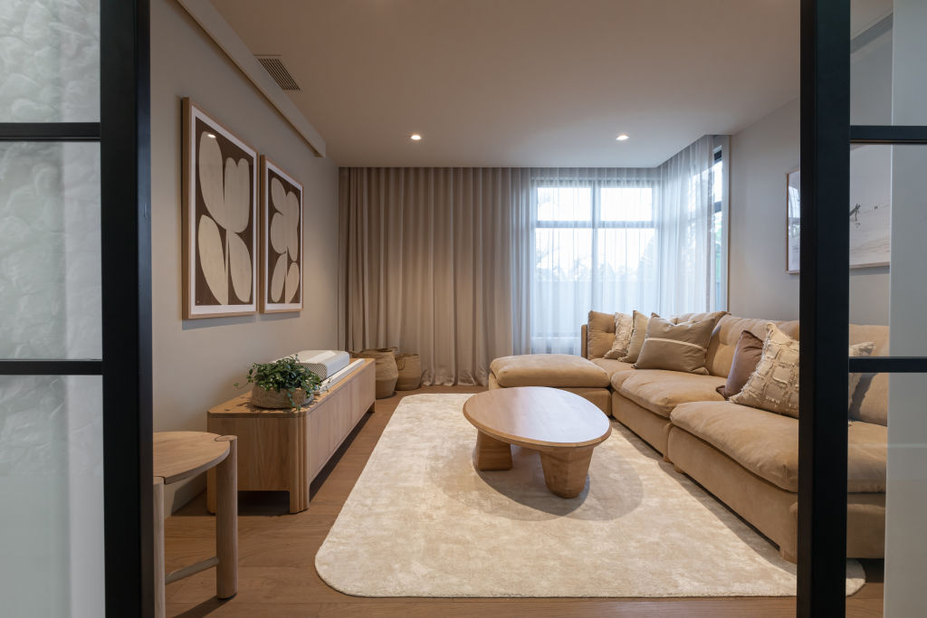 House One's media room uses the same sandy colour on the walls and the ceiling to create a warm, cosy feeling. Photo: Grace Picot