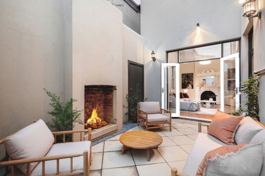 A rear paved courtyard with fireplace is an ideal spot to entertain. Photo: Marshall White Port Phillip