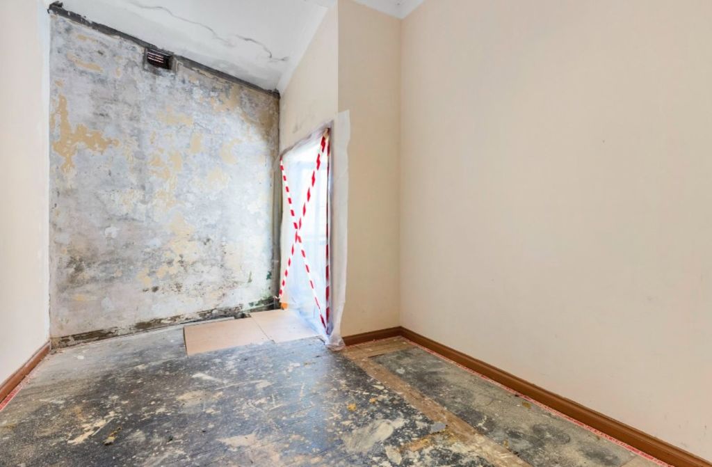 There is hazard tape and uneven floors in one room. Photo: Belle Property Balmain