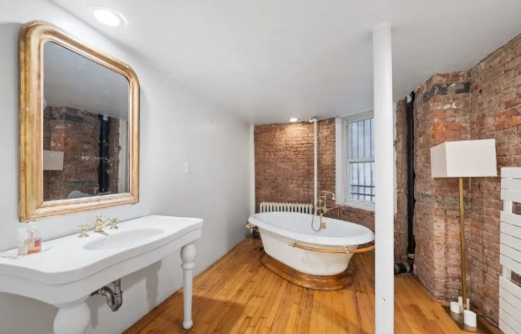 Exposed brick walls in the bathroom give an industrial feel to the space. Photo: JLL