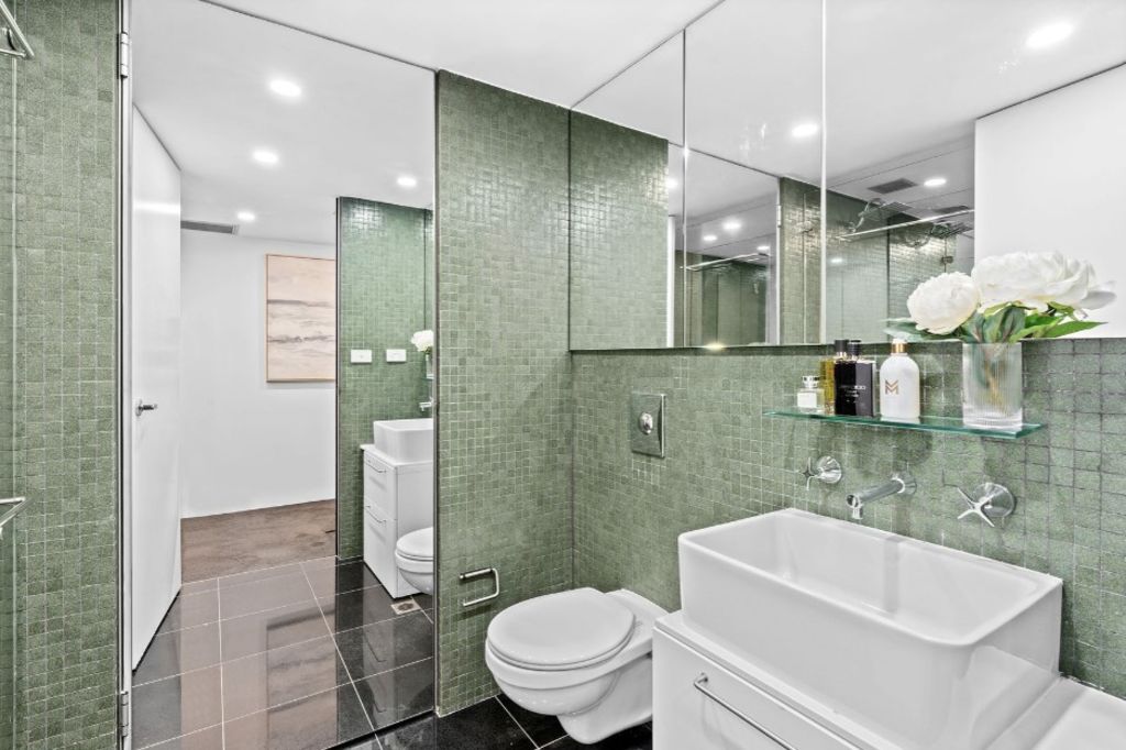 The bathroom features calming green tilework. Photo: Nine