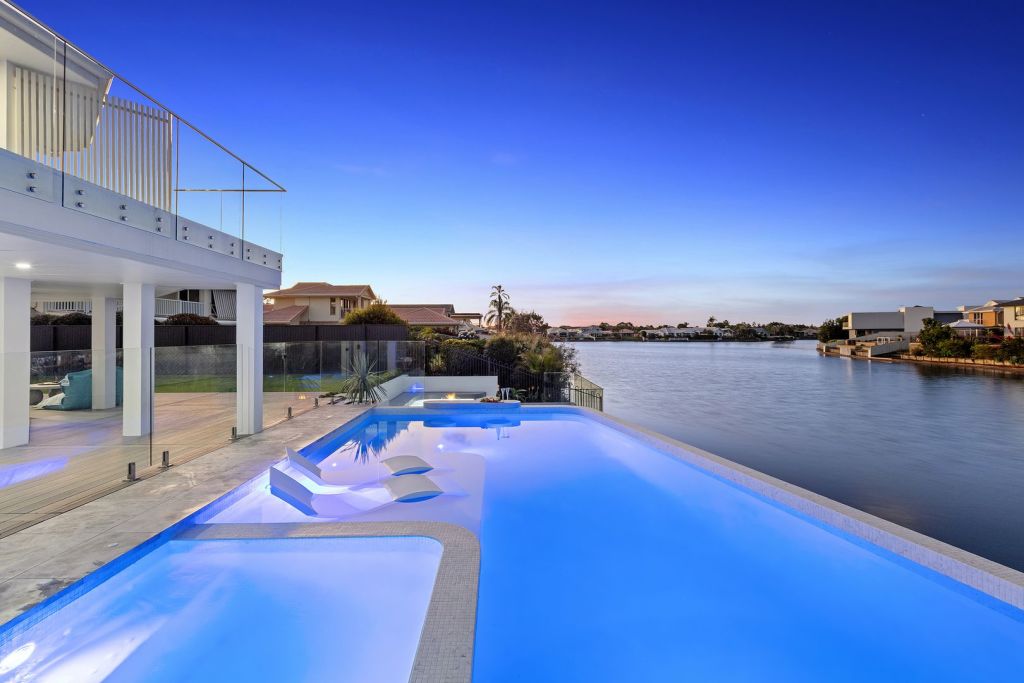 The magnesium pool meets the water at 17 Stirling Castle Court, Pelican Waters. Photo: Queensland Sotheby's International Realty
