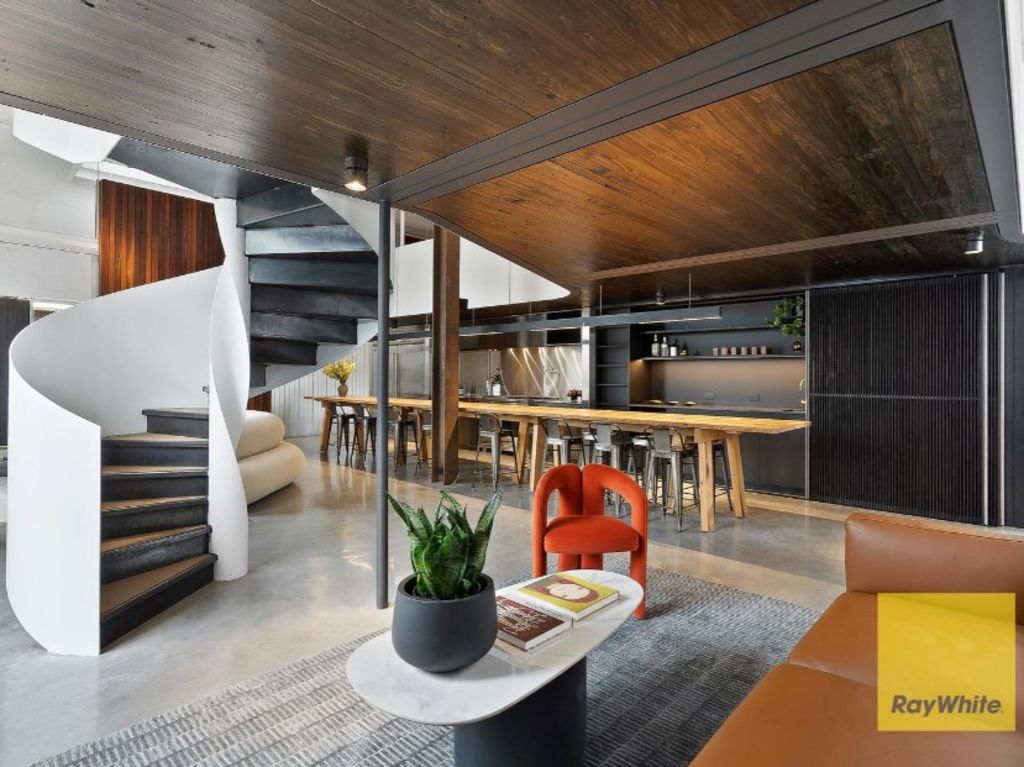 An industrial aesthetic is evident with polished concrete, exposed beams and reclaimed timber. Photo: Ray White