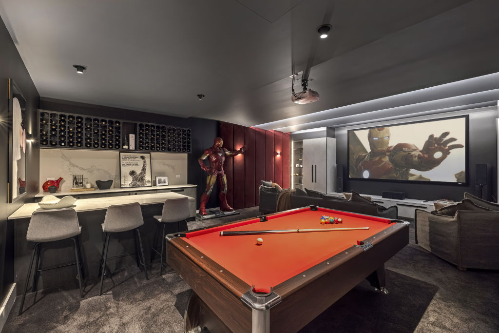 The home features a moody underground theatre room with a bar. Photo: Estate Imagery