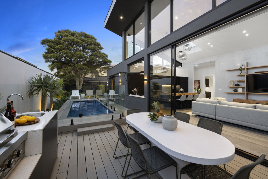 The living space opens to an outdoor dining and kitchen area. Photo: Estate Imagery