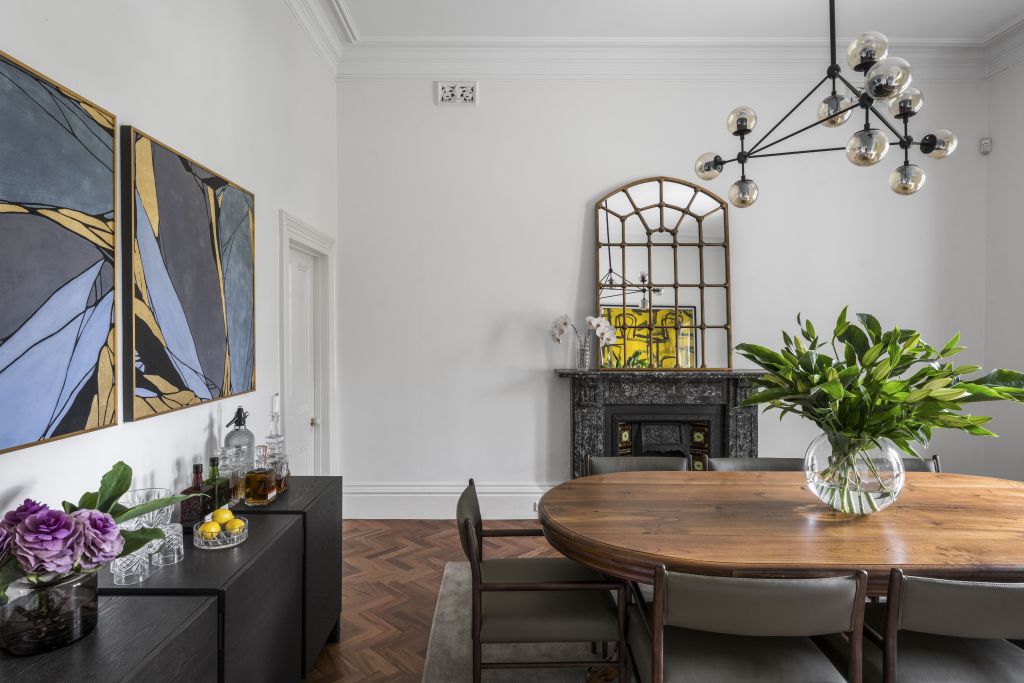 The dining room features a dark marble fireplace.