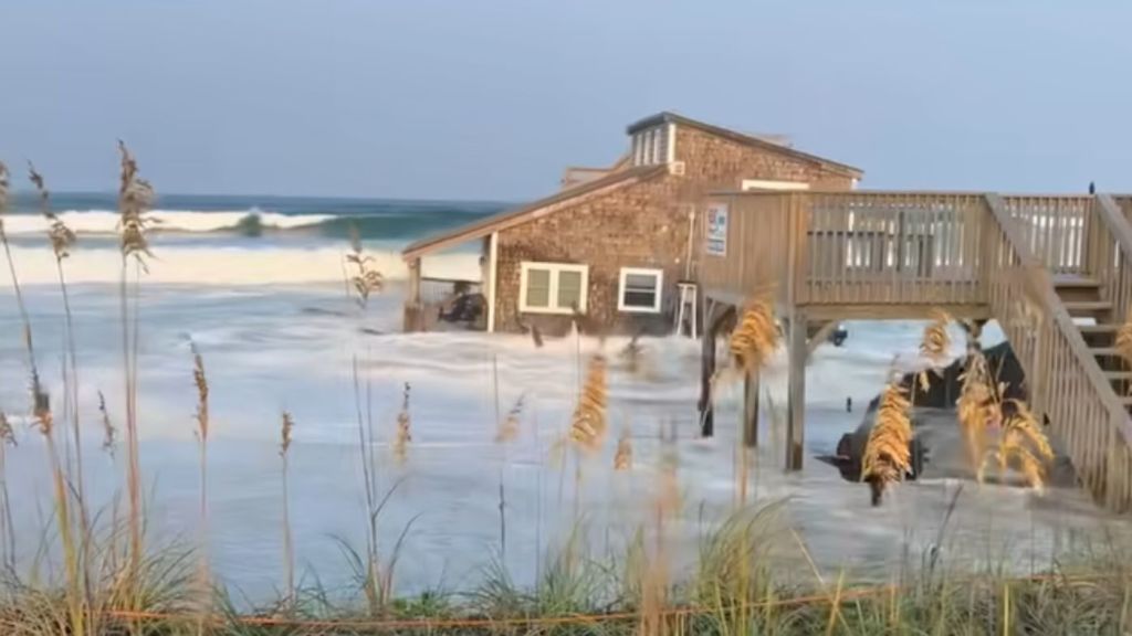 The home is washed into the Atlantic Ocean and onlookers scream and cry out. Photo: Chicamacomico Fire and Rescue