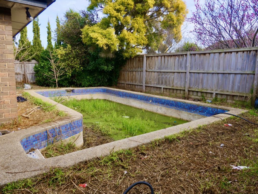 The property is under offer, with an in-ground pool wrapped by the lawn in need to a clean out.