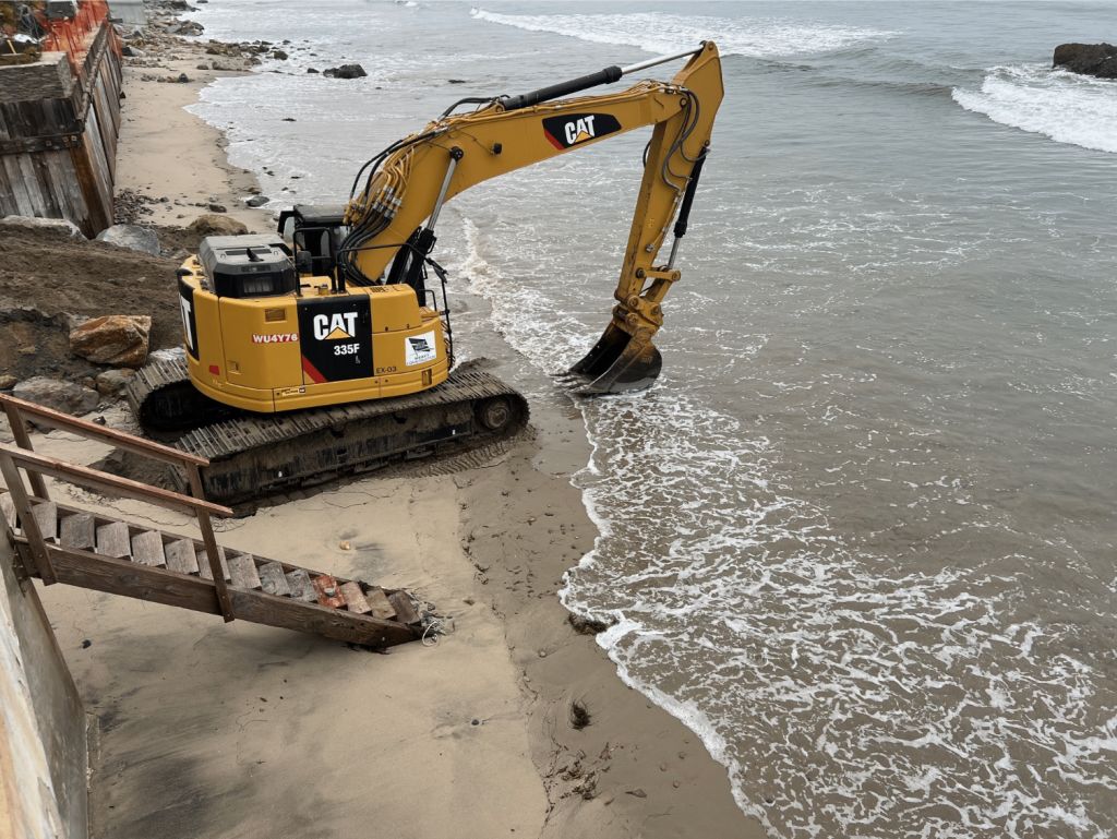 Tide encroaching on excavator. Photo: Supplied to court