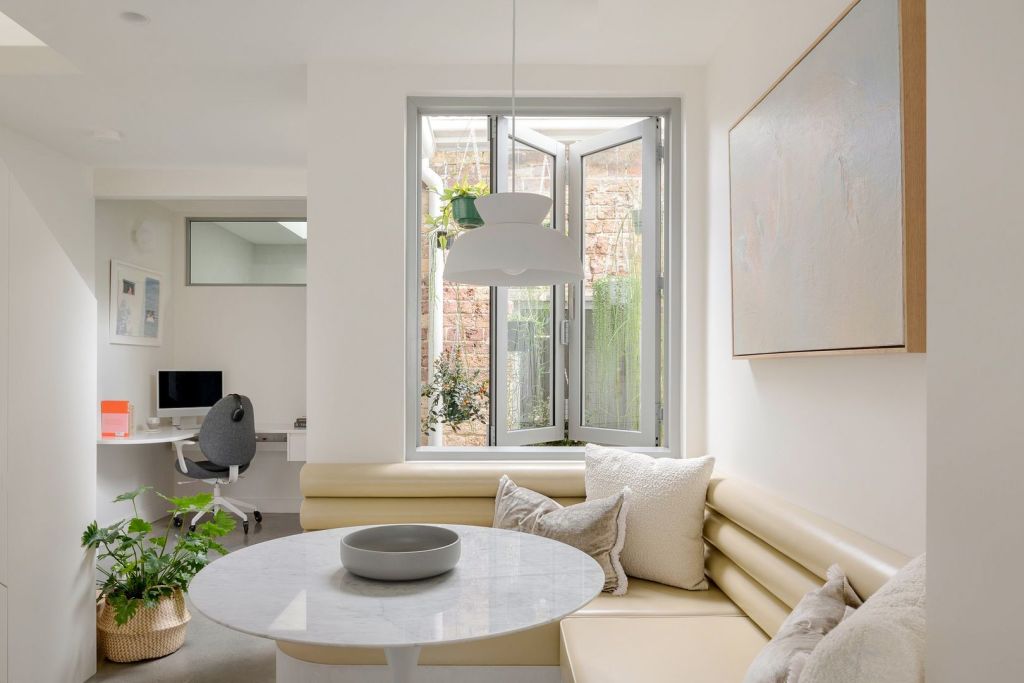 An internal courtyard filled with hanging plants brings light into the interior. Photo: BresicWhitney Inner West