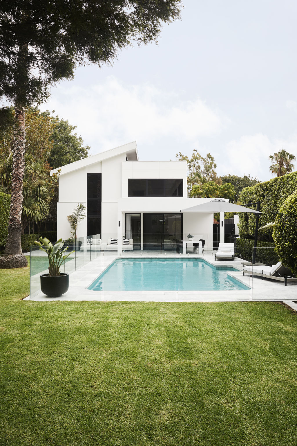 The pool area has been re-paved with exquisite honed travertine. Photo: Annette O'Brien