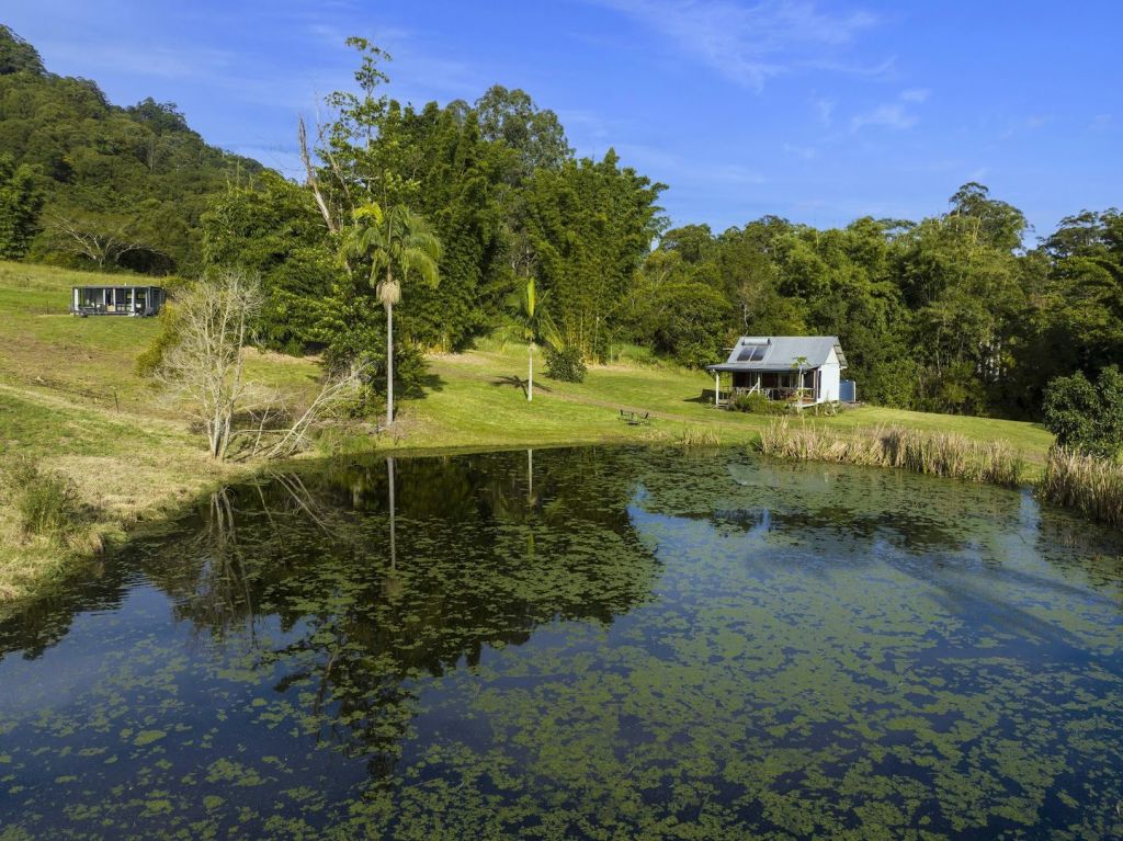 A glass studio, overlooking a dam and the Nightcap Ranges, is a drawcard on the $2.3 million property for sale. Photo: @realty