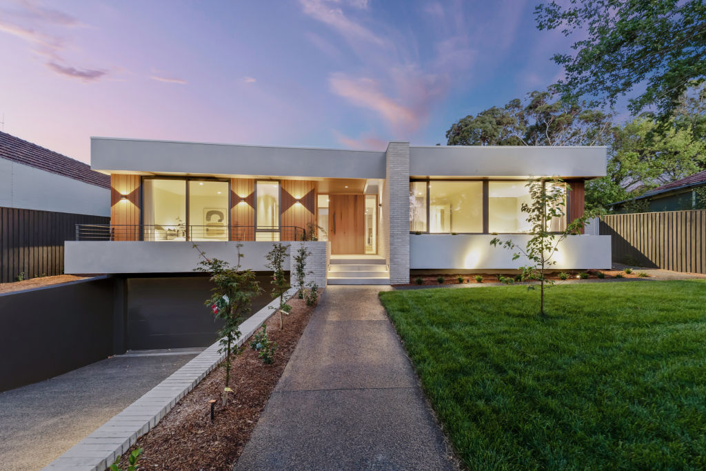 The modern exterior of a high-end Canberra home with large lawn and feature lighting