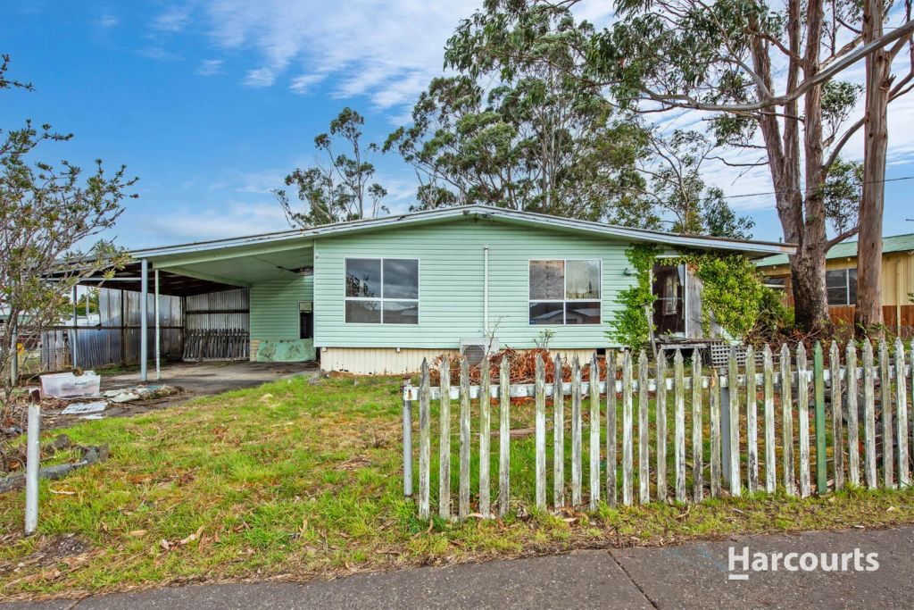 Blue weatherboard house in need of repair.